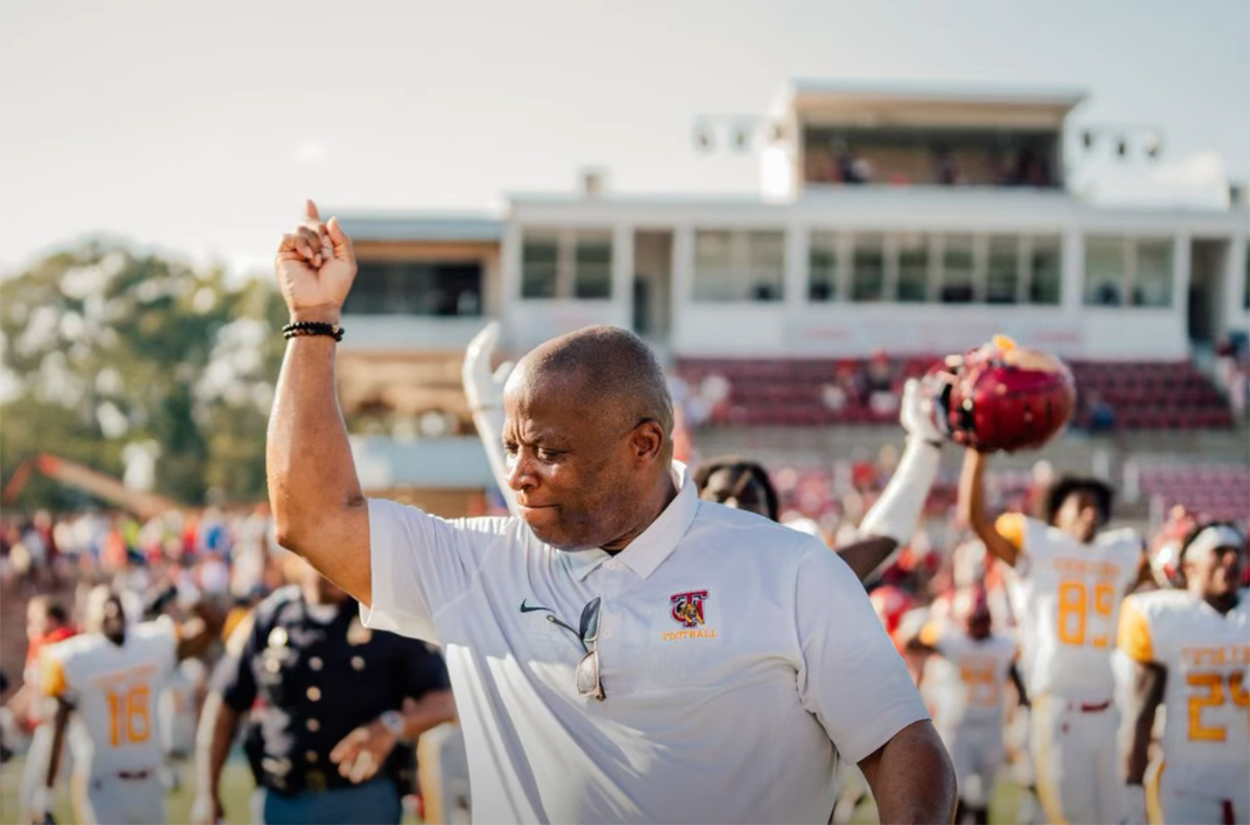 Picture of Reginald Ruffin on the field celebrating a win with the football team