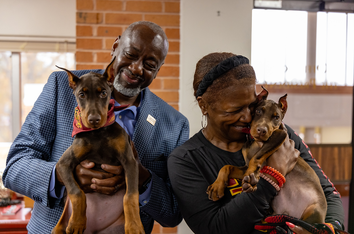 President and Mrs Brown holding their dogs named Crimson and Piper