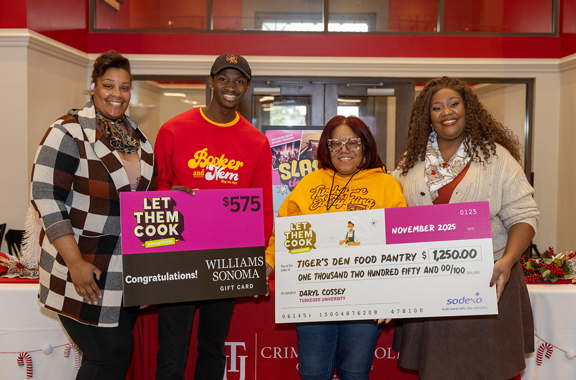 Student contest winner and university student administrators at the Tiger's Den