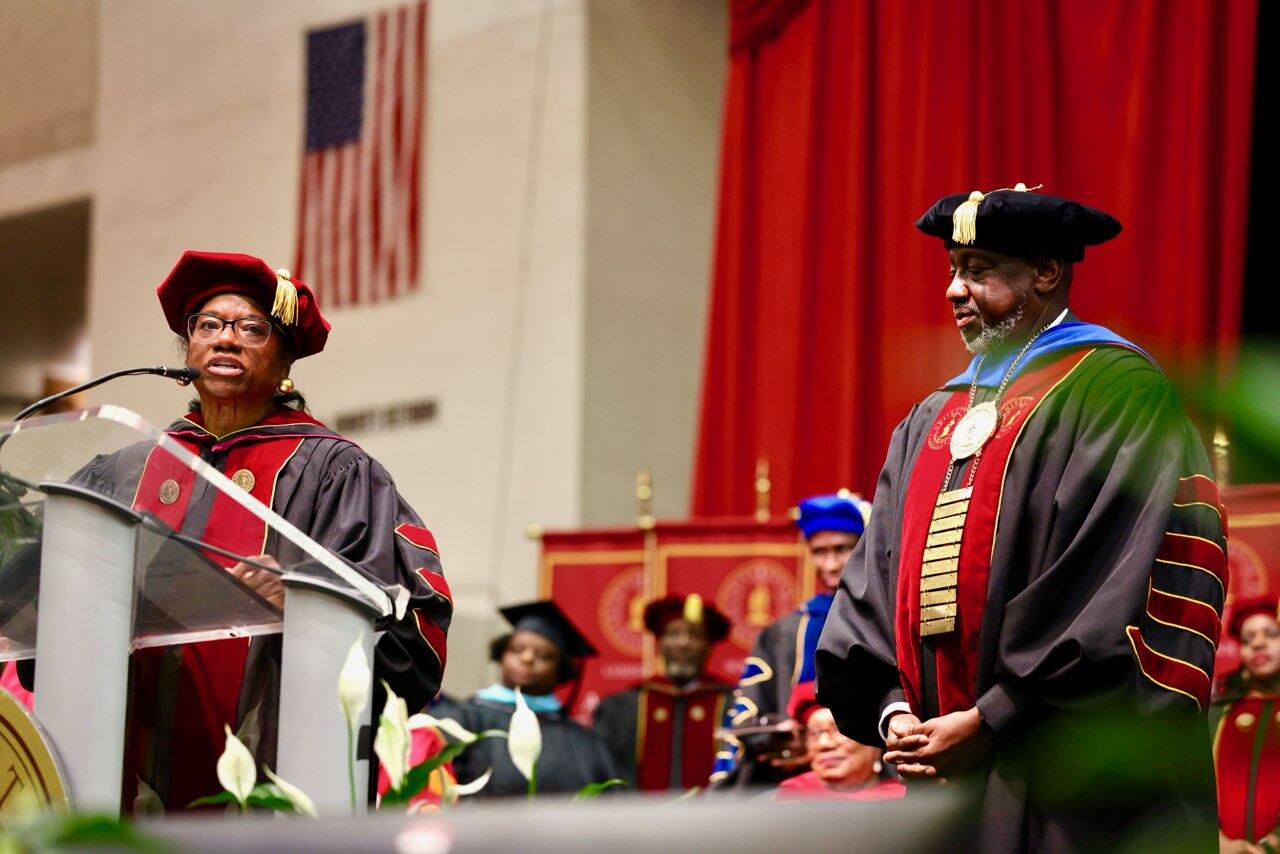 Board Chair Clayton gives remarks as Dr. Brown looks on