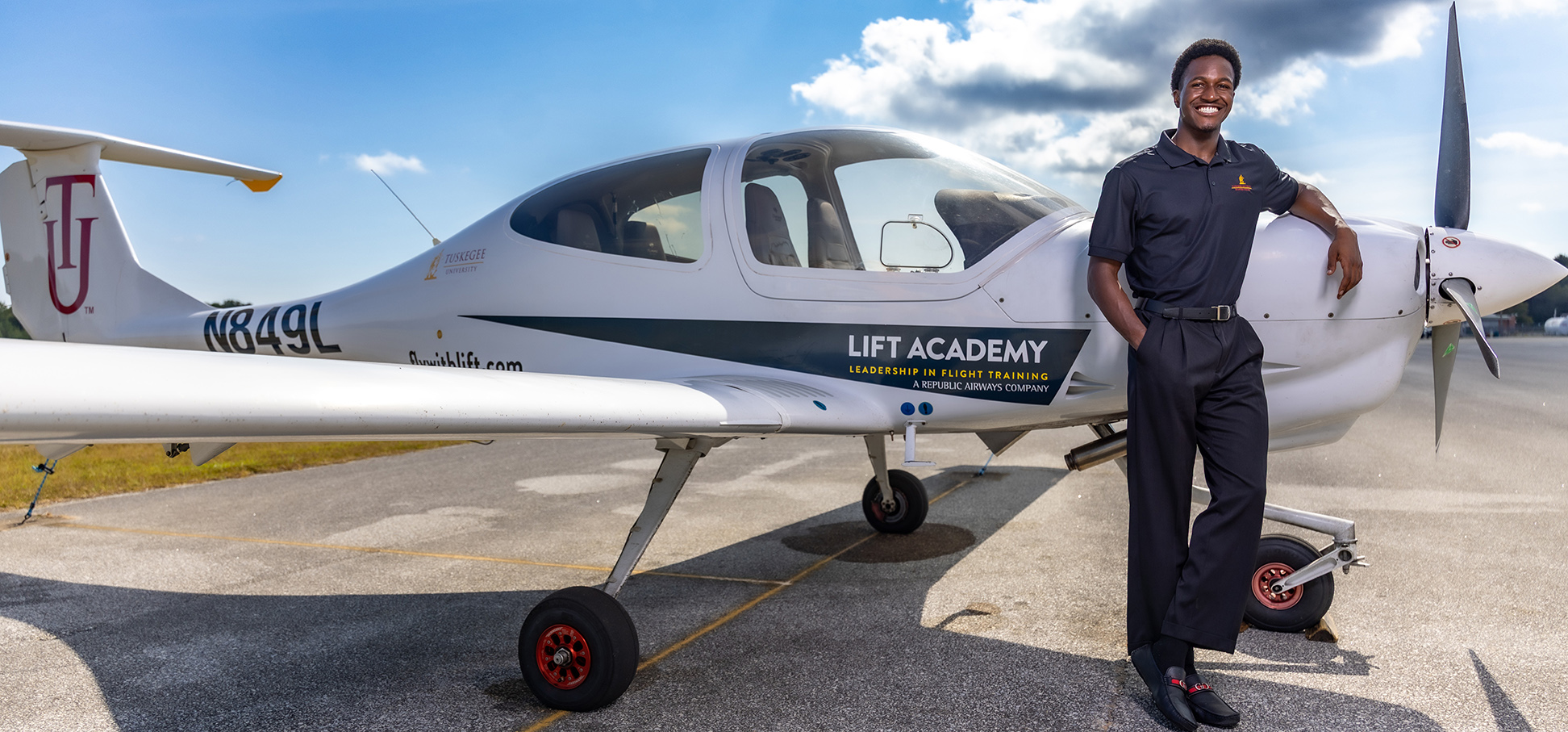 Student pilot standing by small airplane