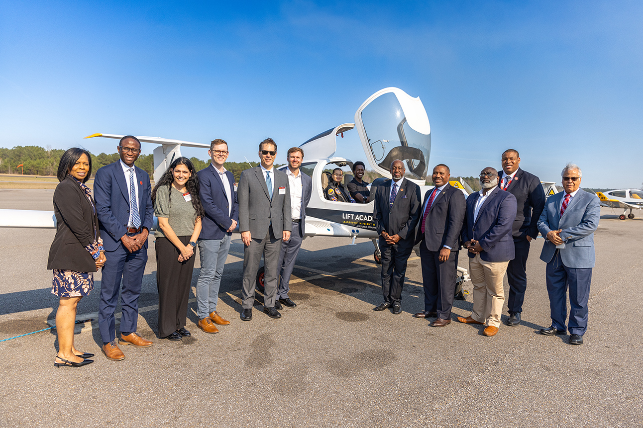 Tuskegee University Officials with Airbus officials standing at airplane 