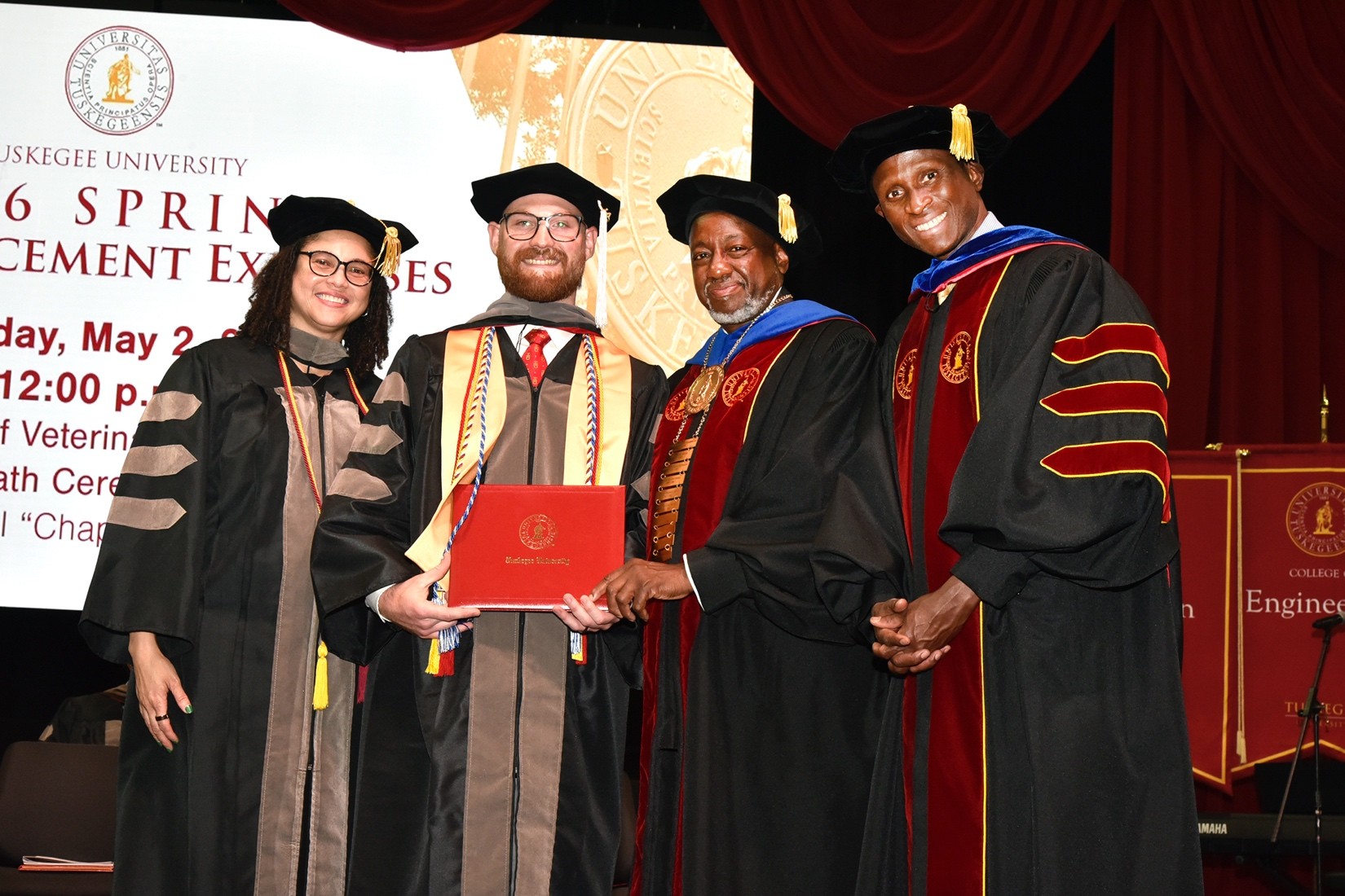 Last grad Eli Vance with President Brown, Dean Gilbreath, and Provost Thiam