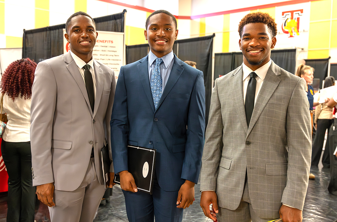 Three TU male students dressed in suits and ties