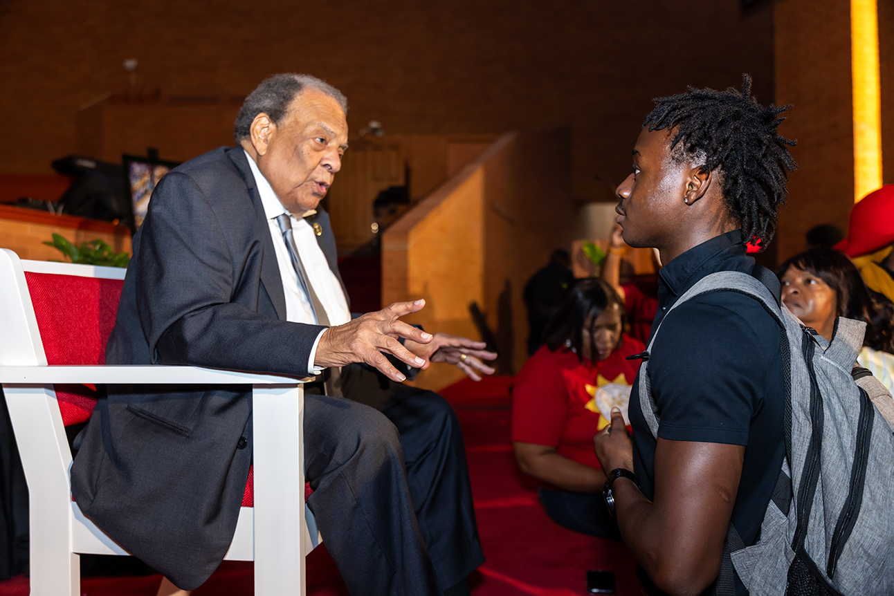 Ambassador Andrew J. Young explains something to student