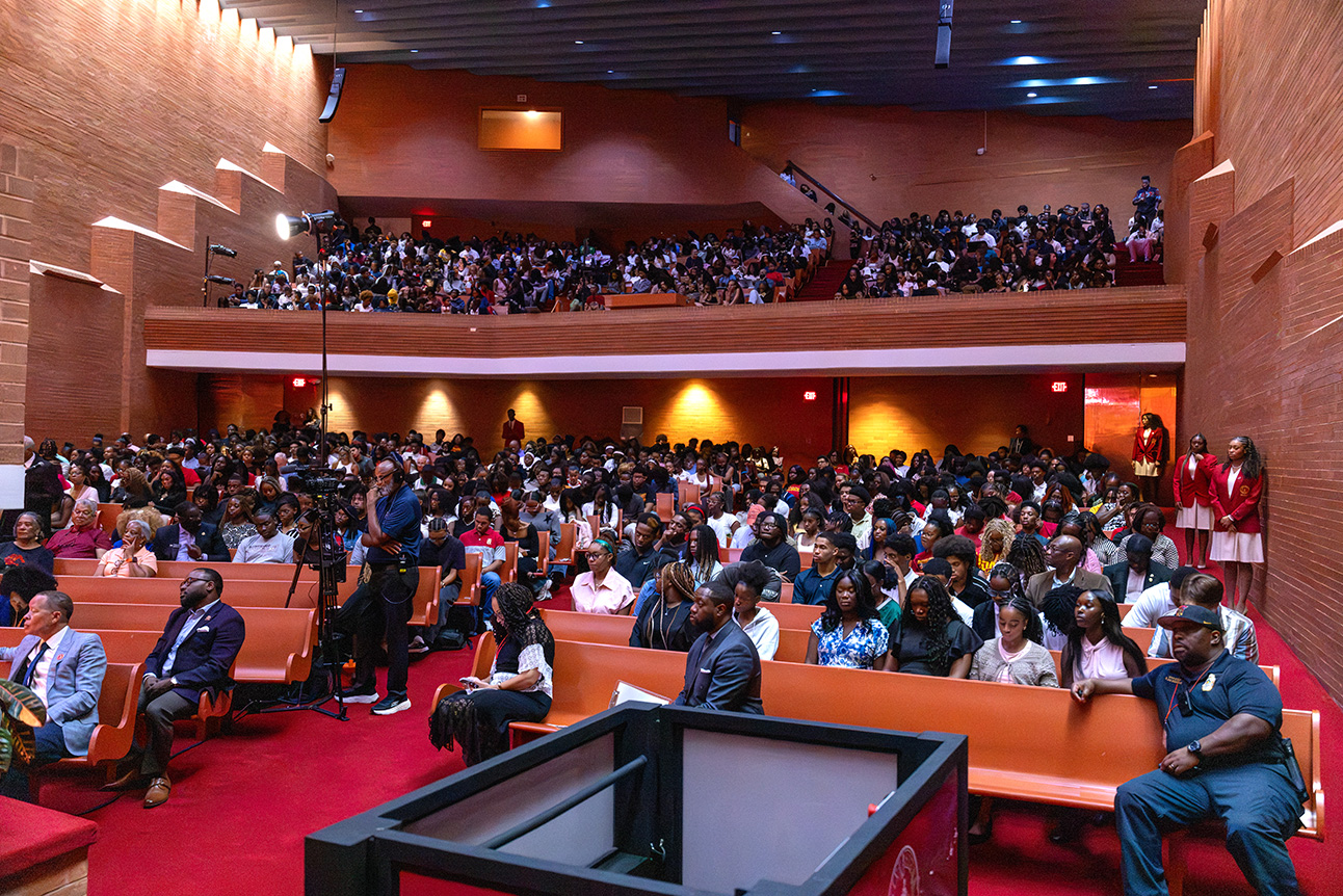 Audience listens to dialogue between Ambassador Young and Kennedi