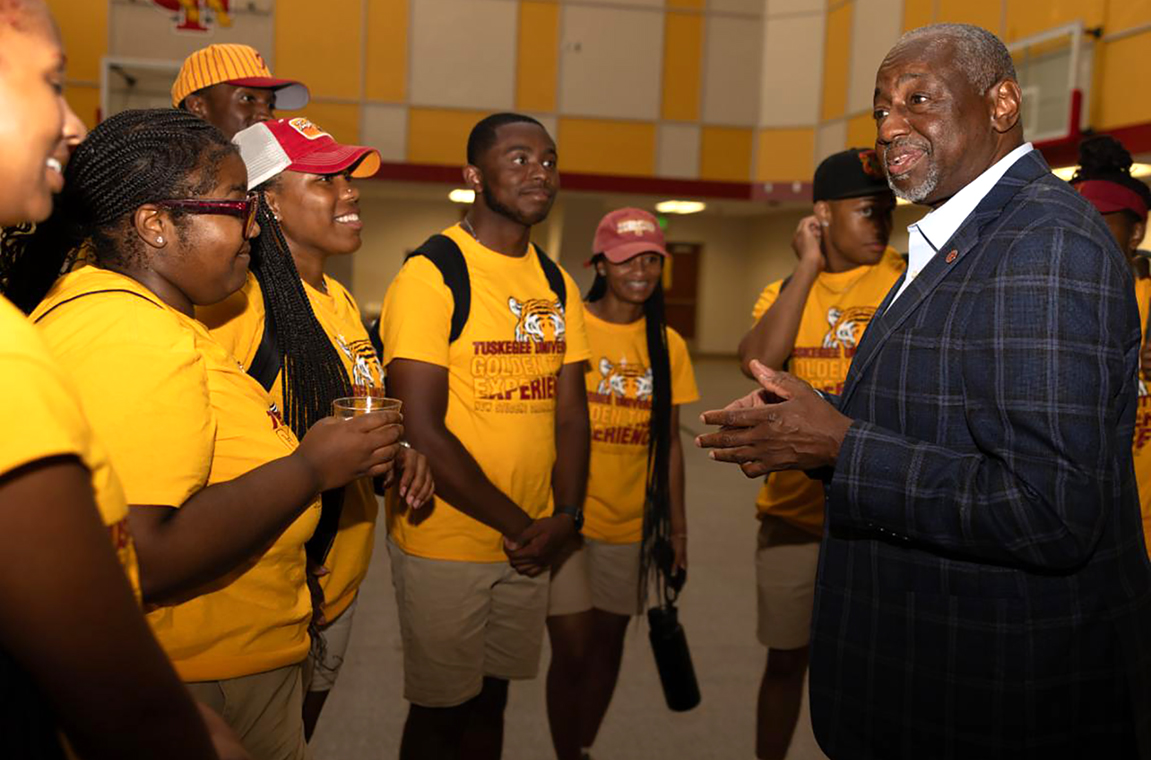 Dr. Mark A. Brown talks with students in Logan Hall