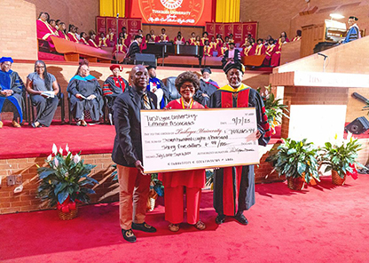Eminent Associates chairwoman and TNAA representative present the check to Dr. Mark A. Brown for the University.